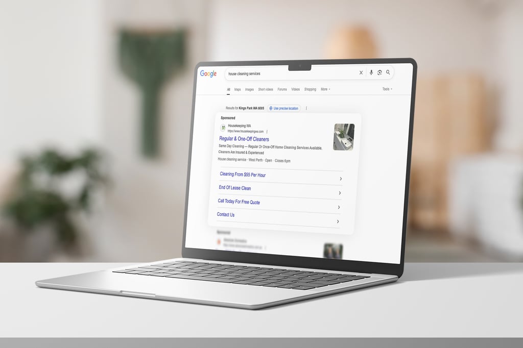 A laptop on a white table displays a Google search results page for housekeeping services in WA, showing sponsored listings and cleaning service options. The background is softly blurred.