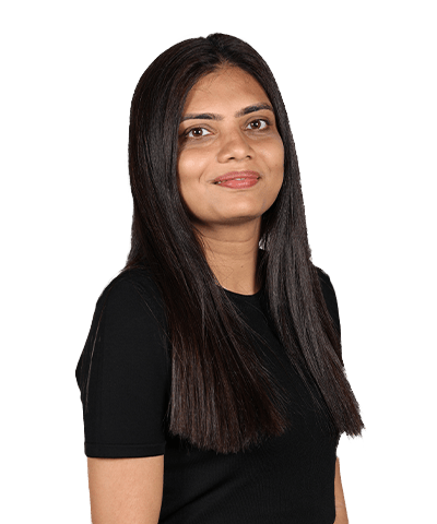 A woman with long, straight dark hair wearing a black short-sleeve shirt, smiling softly and standing against a plain white background.