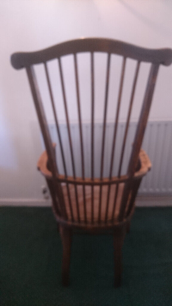 Antique High spindleback chair with matching armrests and padded seat.