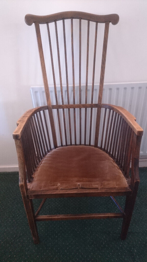 Antique High spindleback chair with matching armrests and padded seat.