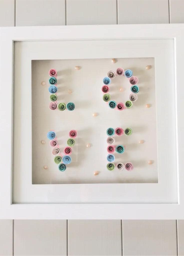 White framed picture with decorative paper and pearl love motif detail