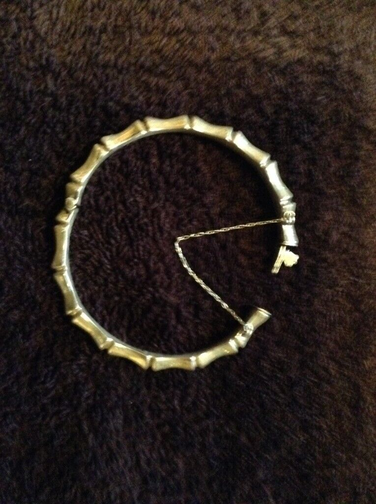 Bangle,silver ‘bamboo‘ style wrist bangle with safety chain, adult size.