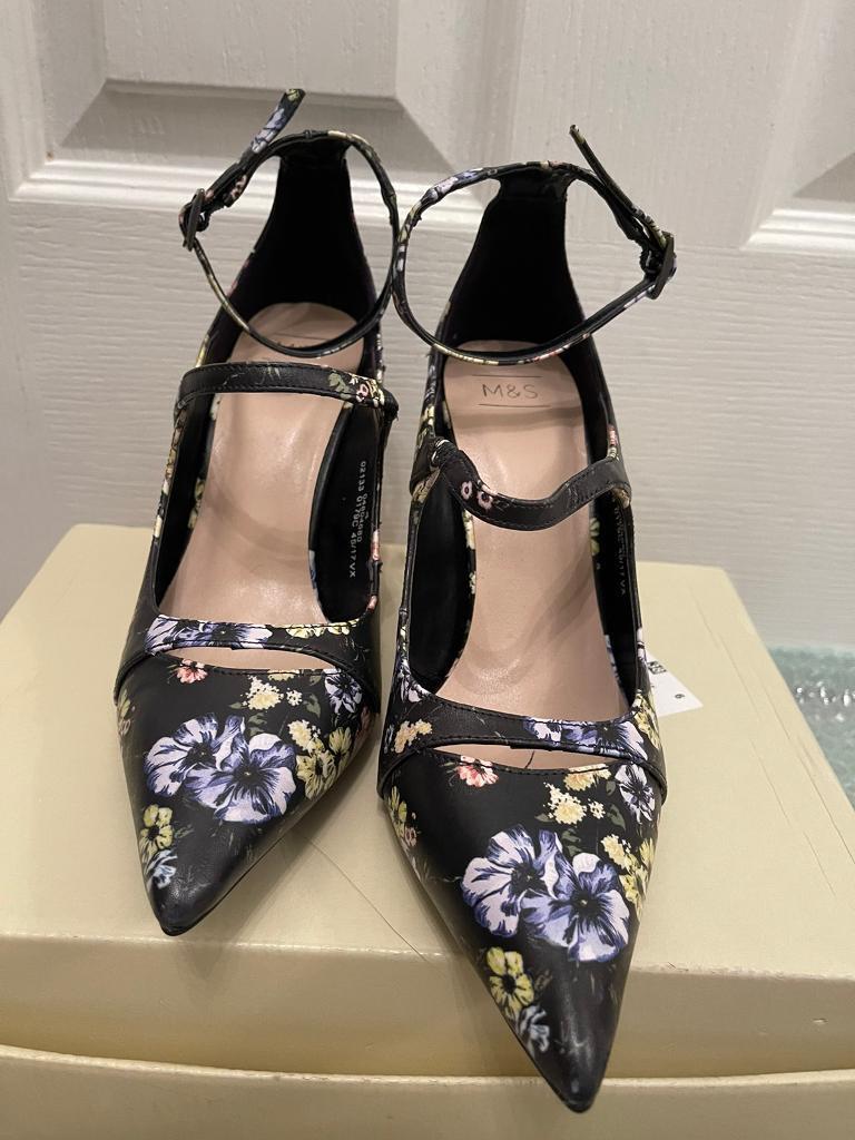 New, never worn. Lovely flower pattern high heels. Size 4