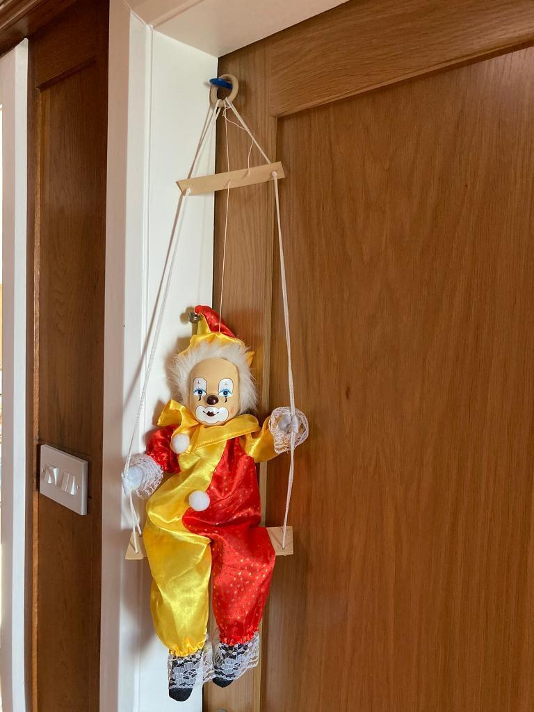 Vintage puppet clown on swing 