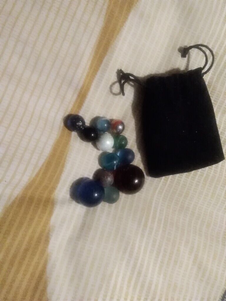 12 very collectible marbles and pouch few rare ones