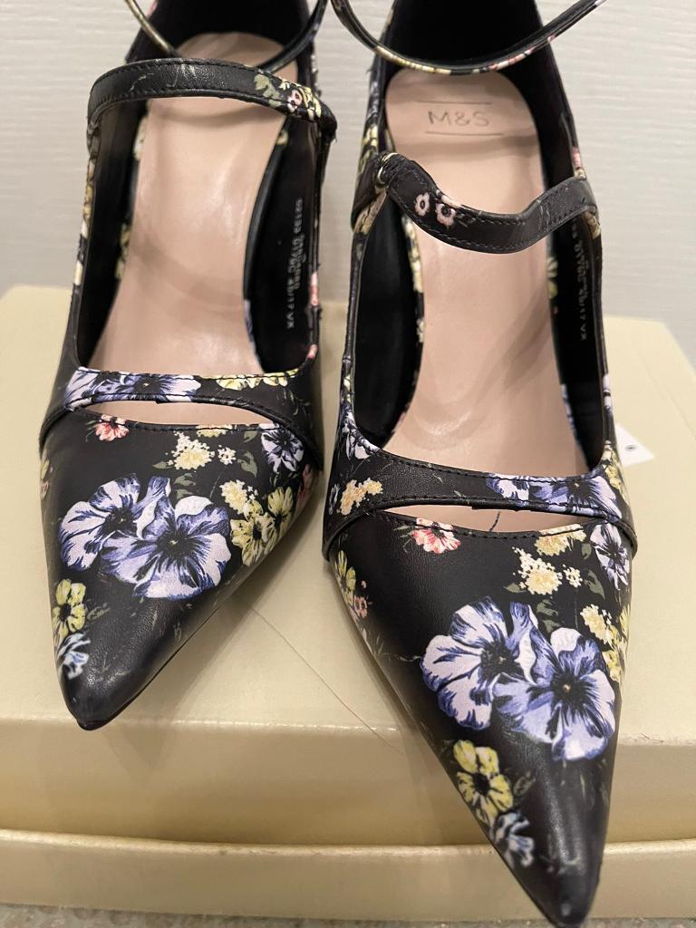 New, never worn. Lovely flower pattern high heels. Size 4