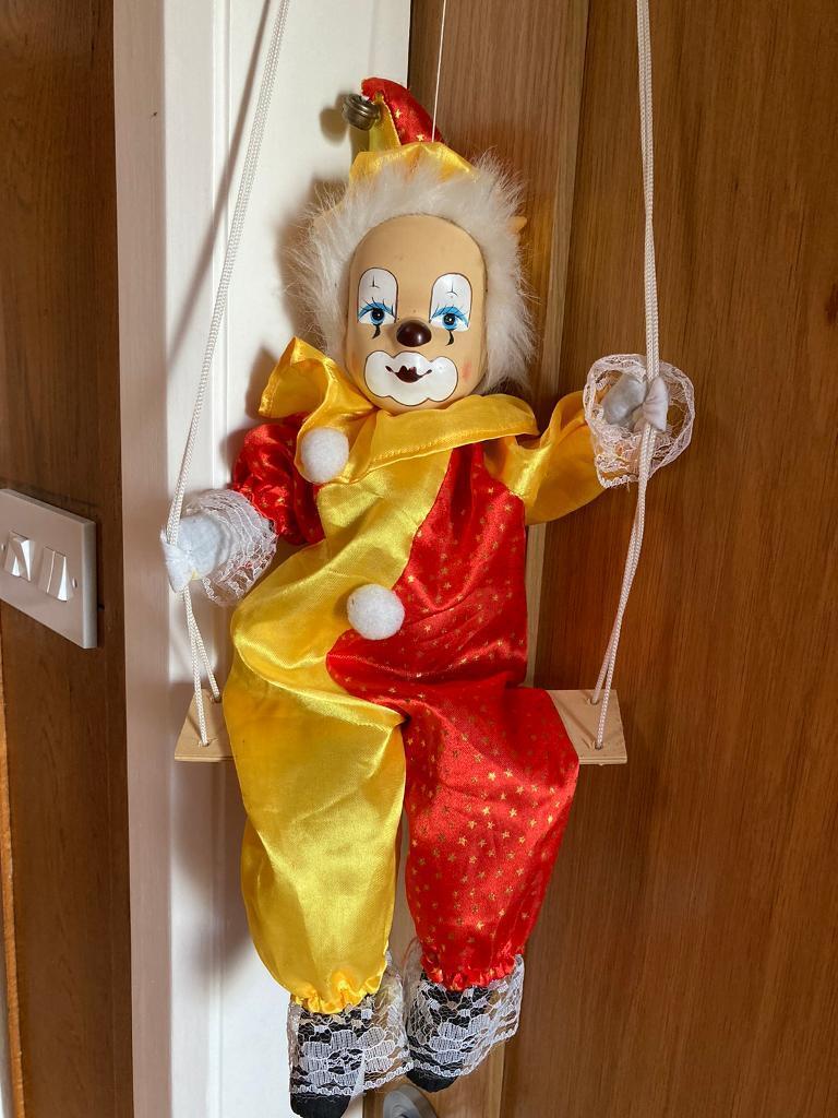 Vintage puppet clown on swing 
