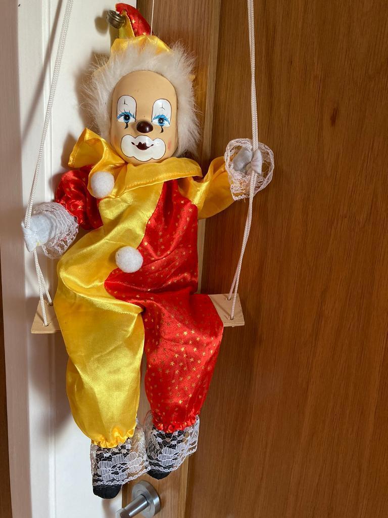 Vintage puppet clown on swing 