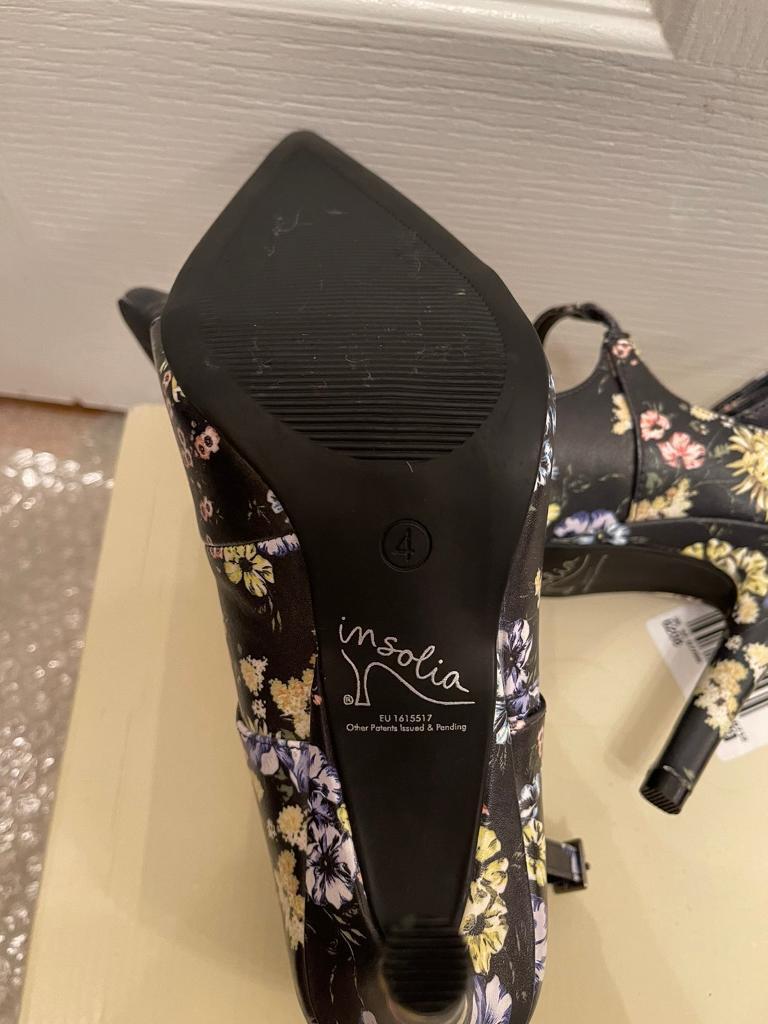 New, never worn. Lovely flower pattern high heels. Size 4