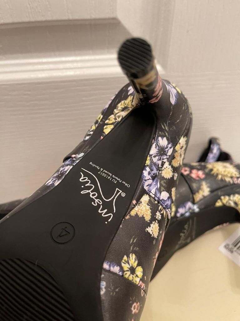 New, never worn. Lovely flower pattern high heels. Size 4