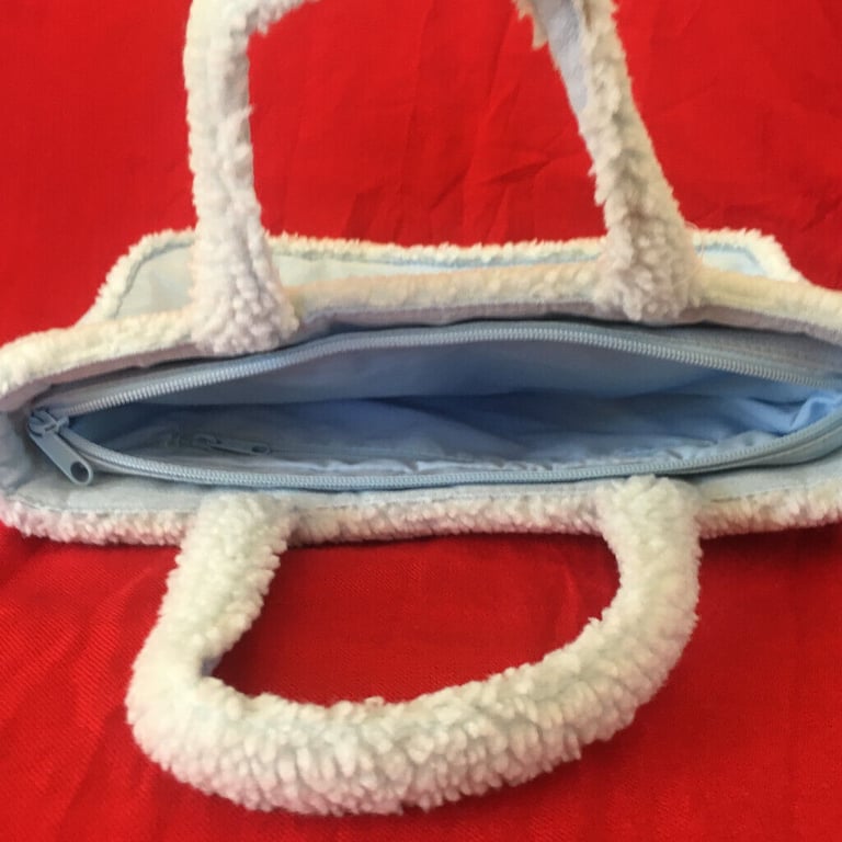  	Unused M&S pale blue suede and lambs wool effect bag. Happy to post. £4 ovno.