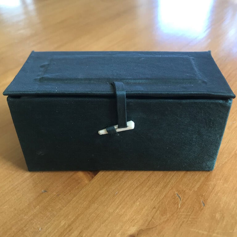 image for Presentation or gift box: covered in dark green fabric, with closure. Padded interior.