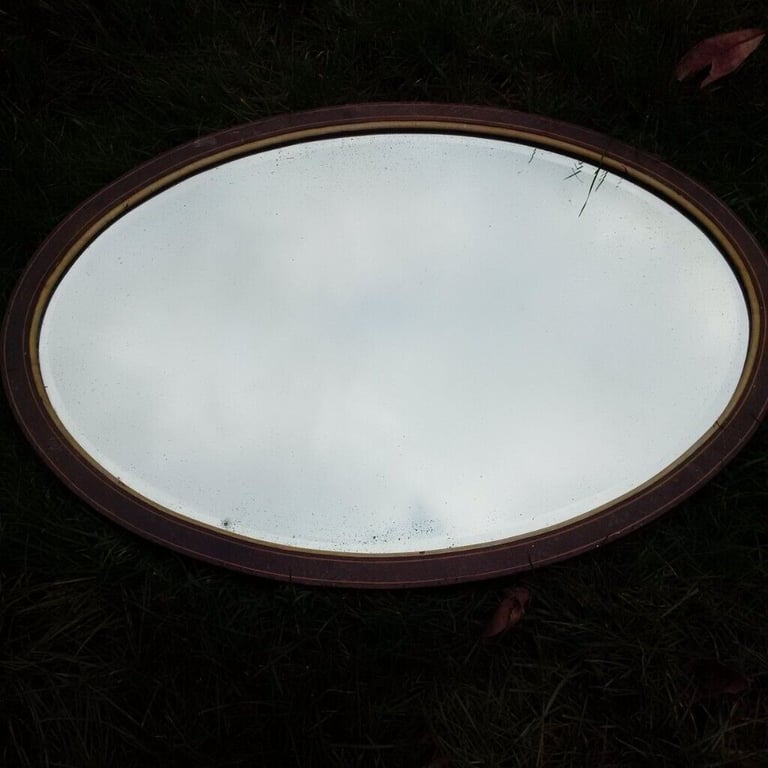 large vintage oval mirror in nice detailed wooden frame