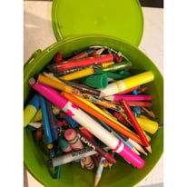 Tub full of crayons and pencils
