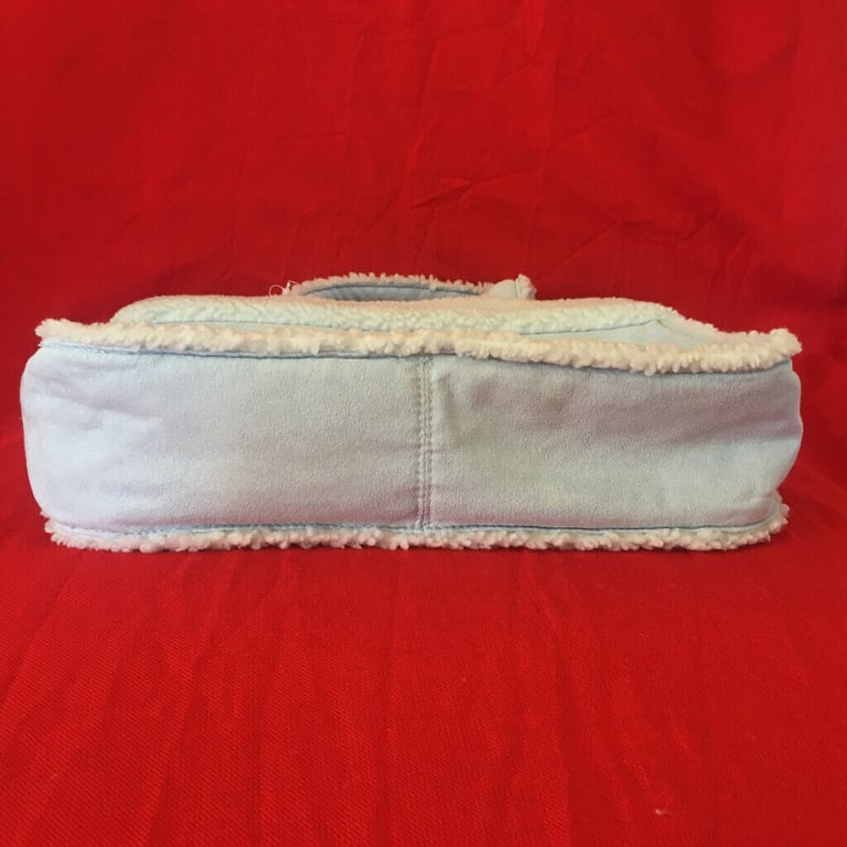  	Unused M&S pale blue suede and lambs wool effect bag. Happy to post. £4 ovno.