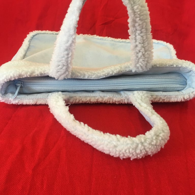  	Unused M&S pale blue suede and lambs wool effect bag. Happy to post. £4 ovno.