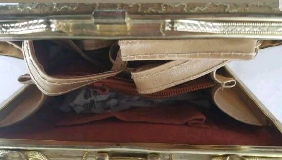 ladies gold colour handbag with different colour studs on it
