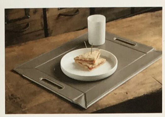 	Unused reversible red/beige freeform faux leather tray/placemat.Original packaging. £12 ovno.