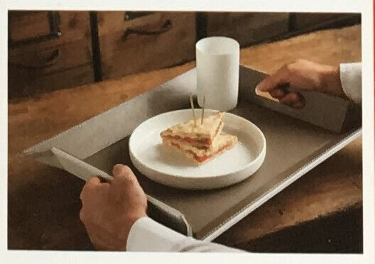 	Unused reversible red/beige freeform faux leather tray/placemat.Original packaging. £12 ovno.