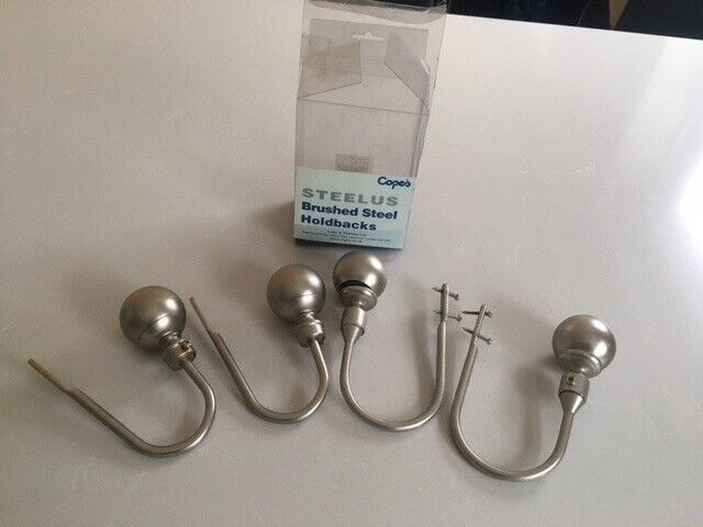 Decorative curtain tie-backs in brushed steel finish