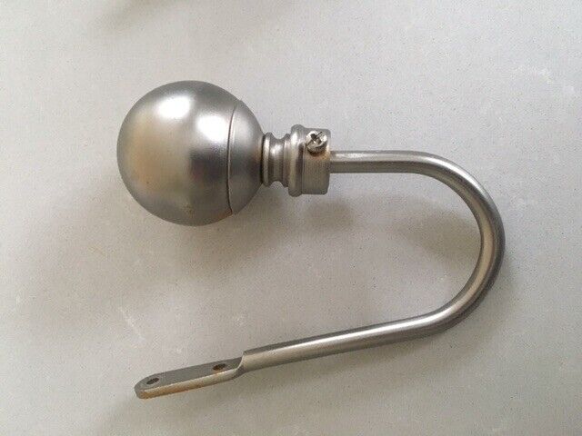 Decorative curtain tie-backs in brushed steel finish