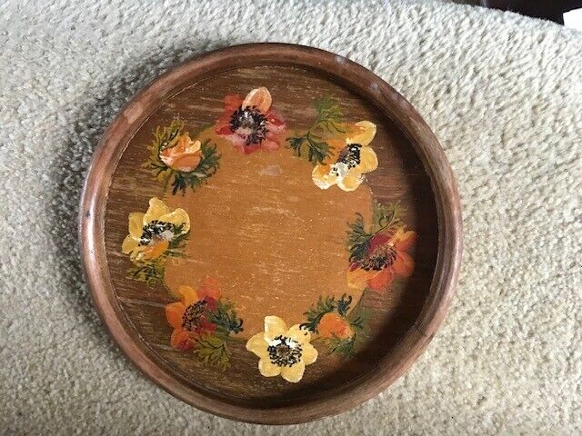 A vintage wooden tea pot stand