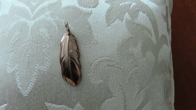 Brand new silver pendant, gilded and with one small diamond, in the shape of a leaf£ 15