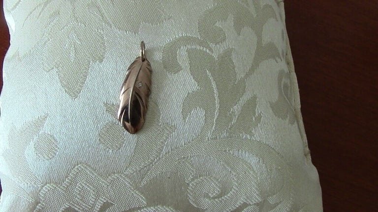 Brand new silver pendant, gilded and with one small diamond, in the shape of a leaf£ 15