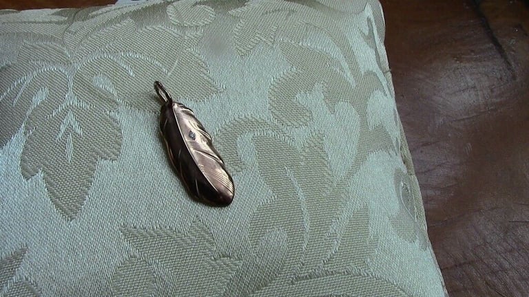 Brand new silver pendant, gilded and with one small diamond, in the shape of a leaf£ 15