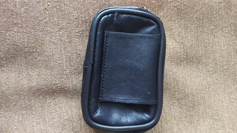 Small, black,good quality leather pouch. New.With loop for belt.