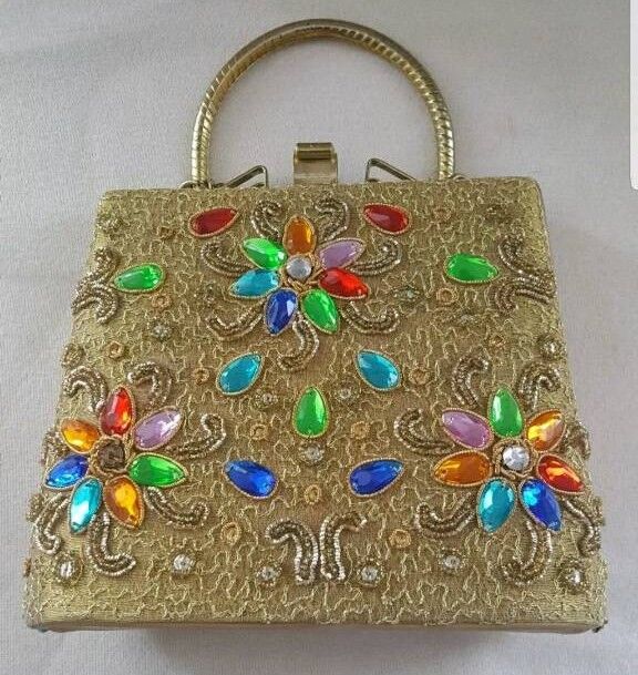 image for ladies gold colour handbag with different colour studs on it