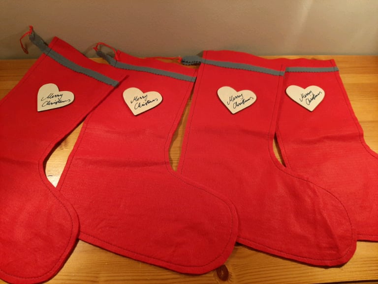Four Red Felt Stockings with Wooden Merry Christmas Heart