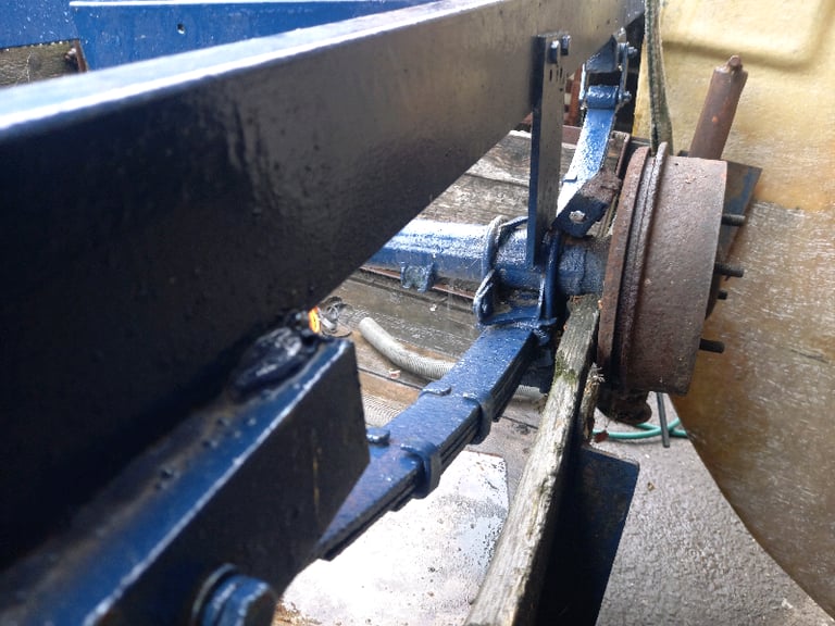 Box trailer frame with early mini type axle.