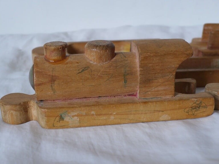 UNUSUAL VINTAGE WOODEN TOY TRAIN. With pieces designed to fit together like a jigsaw puzzle. 