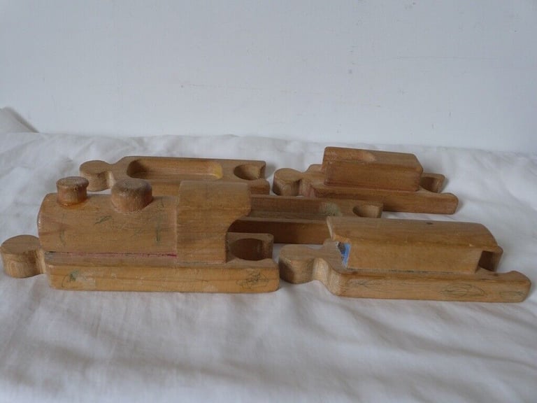 UNUSUAL VINTAGE WOODEN TOY TRAIN. With pieces designed to fit together like a jigsaw puzzle. 