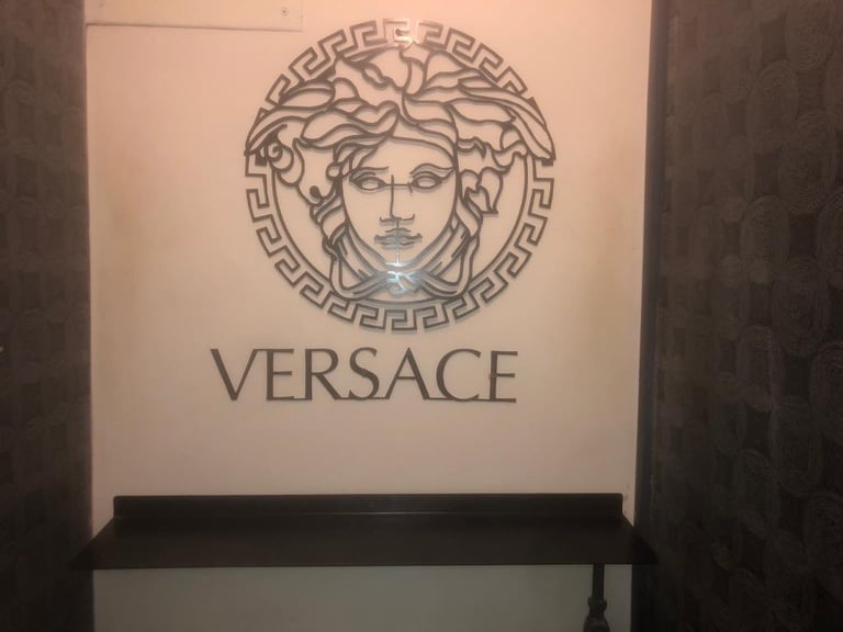 Versace logo sign and shelve