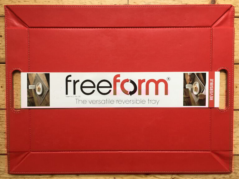 image for 	Unused reversible red/beige freeform faux leather tray/placemat.Original packaging. £12 ovno.