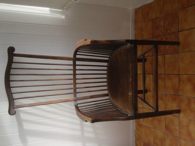 Antique High spindleback chair with matching armrests and padded seat.