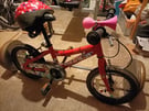 Childs red bike with stabiliers 