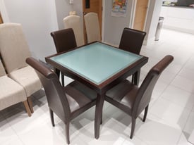 Dark wood and glass dining table and 4 leather chairs