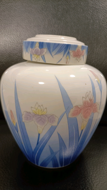 A porcelain vase with water lilly flowers and gold rim