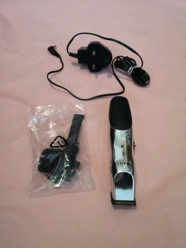 Wahl rechargeable beard/hair trimmer with attachments and adapter. 