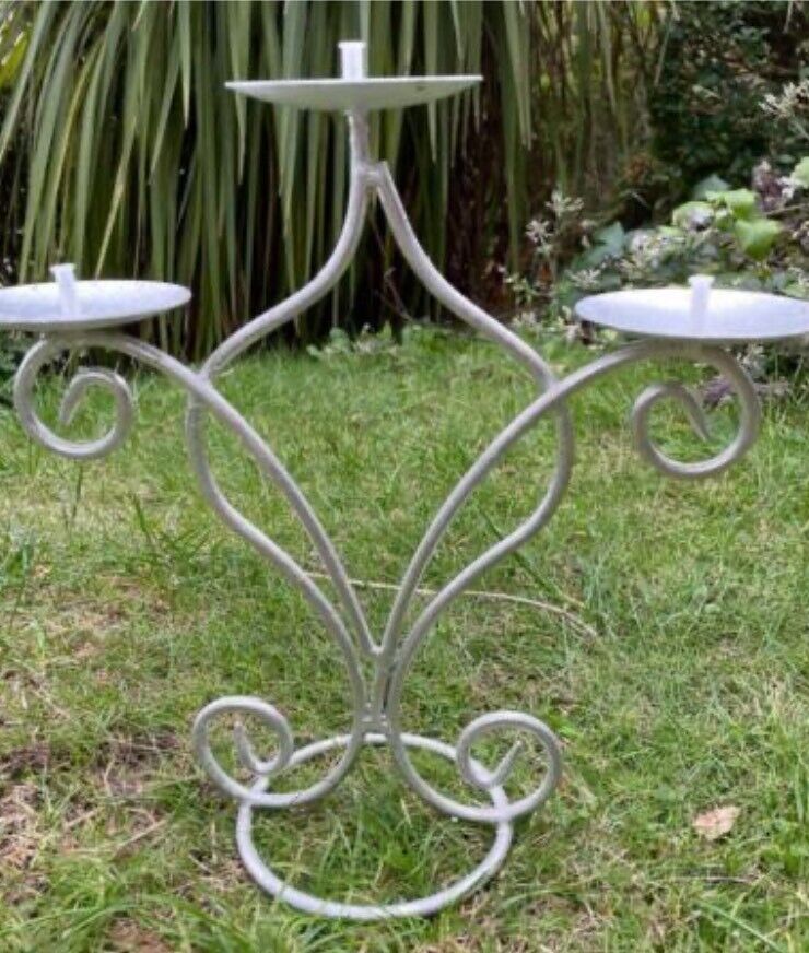 Candle holder (holds 3 candles) in a silver colour