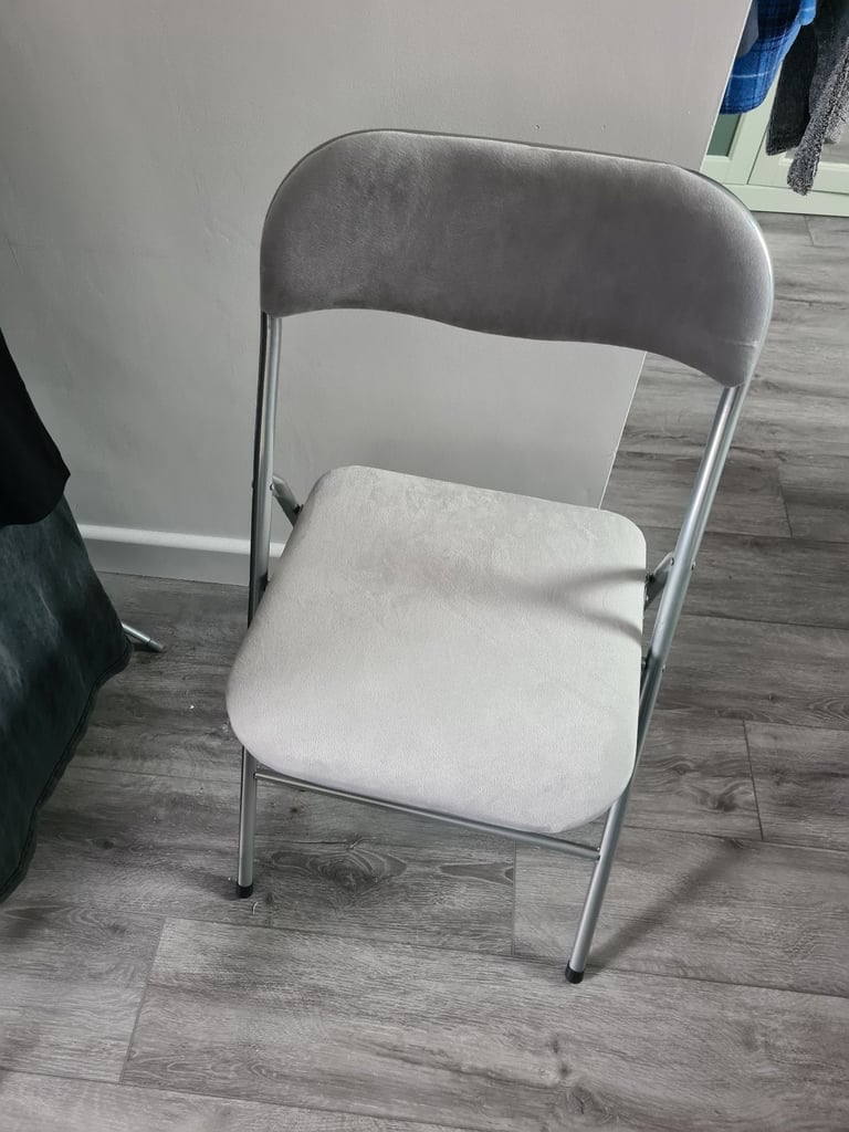 Grey foldable chair.