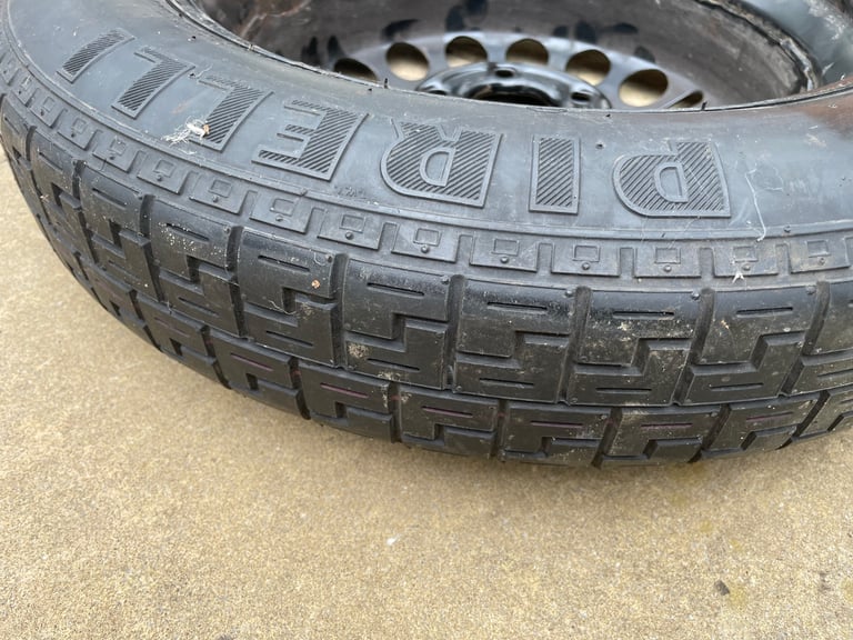 Spare tyre with toolkit