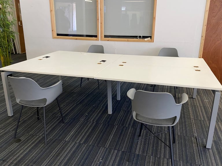 White bank of 4 used office bench desks 1400mm per desk