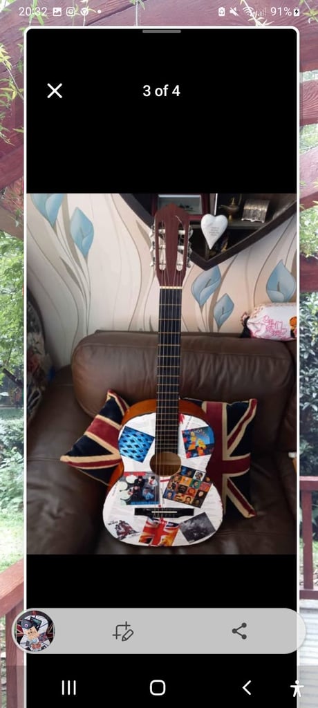 Adult guitar decorated with pictures of the Who, used, still playable 