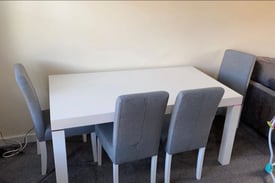 White solid table and 4 grey chairs 