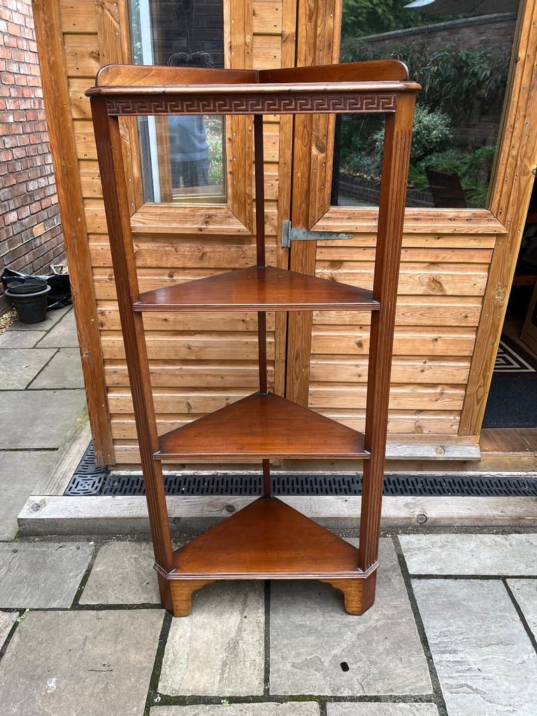 image for A four tier mahogany corner display stand with triangular shelves.