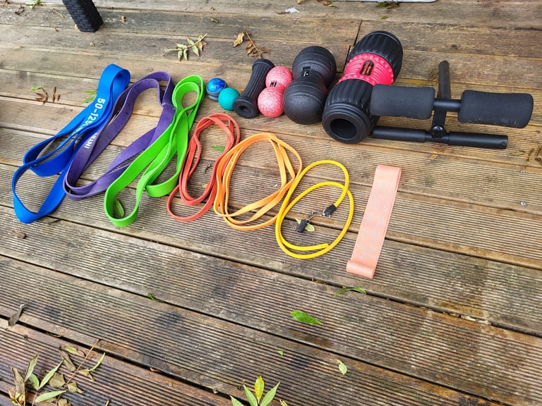 image for home fitness workout equipment resistance bands, massage balls, a foam roller, abdominal roller bar